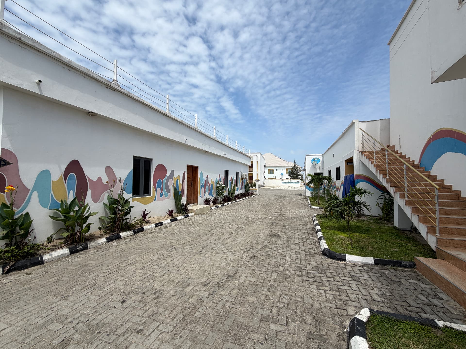 Mural-painted guest room block along the resort's paved courtyard